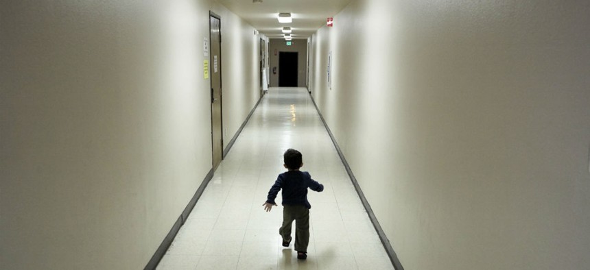 An asylum-seeking boy from Central America runs down a hallway in a San Diego shelter, after arriving from an immigration detention center.