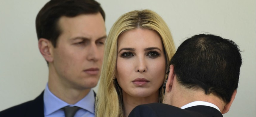 Ivanka Trump, center, talks with Treasury Secretary Steven Mnuchin, right, as her husband, White House senior adviser Jared Kushner, looks on. The couple received security clearances despite objections from intelligence officials.