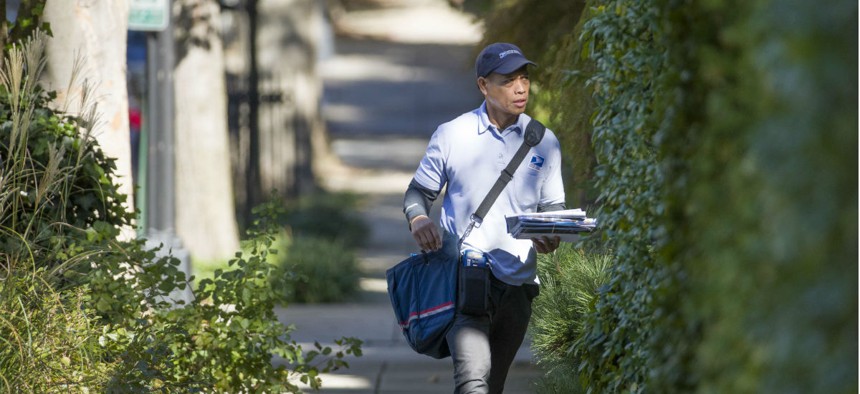 A USPS letter carrier makes the rounds in Washington in 2018.