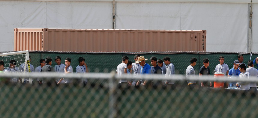 Migrant children walk outside at the Homestead Temporary Shelter for Unaccompanied Children  in 2018 in Florida.