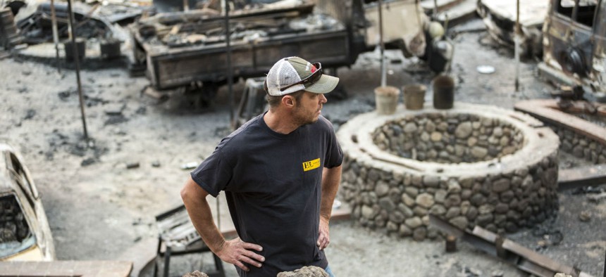 A man stands in the ruins of his burned home in Glen Ellen, California, in October 2017 after wildfires devastated the region. 