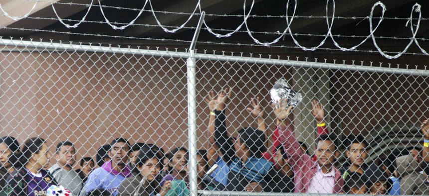 Central American migrants wait for food in El Paso, Texas, on March 27 in a pen erected by CBP to process a surge of migrant families and unaccompanied minors.