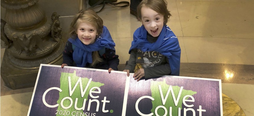 Noelle Fries, 6, left, and Galen Biel, 6, both of Minneapolis, attend a rally at the Minnesota Capitol on Monday, April 1, 2019, to kick off a year-long drive to try to ensure that all Minnesota residents are counted in the 2020 census. 