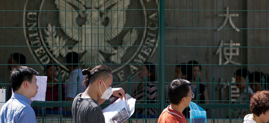 Visa applicants wait to enter the U.S. Embassy in Beijing in 2018.
