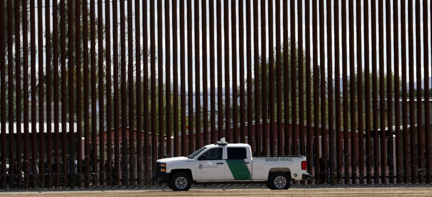A U.S. Customs and Border Protection vehicle sits near the a new section of the border wall with Mexico in Calexico.
