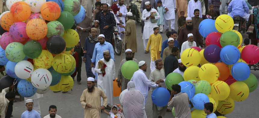 Pakistani people leave after offering Eid al-Fitr prayers to celebrate the end of the holy month of Ramadan in Karachi last year. 