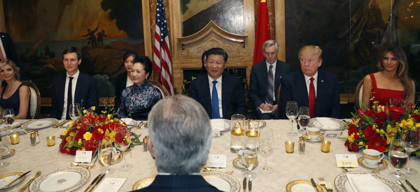 U.S. President Donald Trump and Chinese President Xi Jinping, with their wives, first lady Melania Trump and Chinese first lady Peng Liyuan, are seated during a dinner at Mar-a-Lago in 2017.