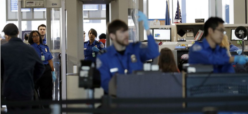 TSA screeners work a checkpoint at Chicago's O'Hare International Airport in January. 