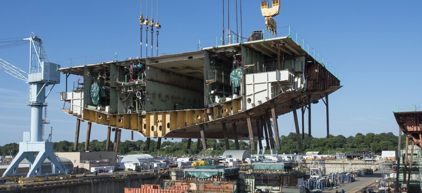 Newport News Shipbuilders lifted a 704-metric-ton aunit into Dry Dock 12, where construction of the aircraft carrier USS John F. Kennedy (CVN-79) is taking shape. 