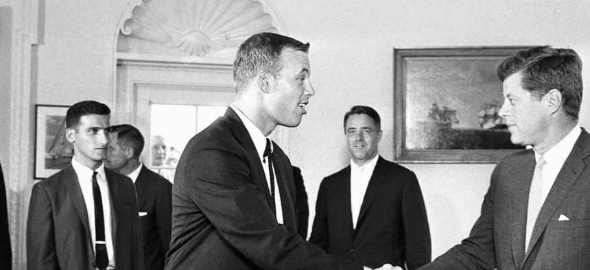 John Kennedy shakes hands with one of the first Peace Corps volunteers in 1961