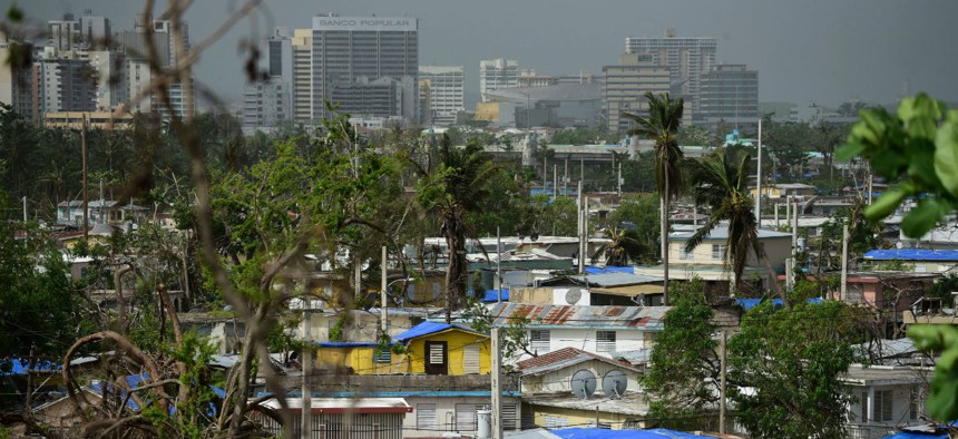 Homes in Puerto Rico stand covered with FEMA tarps in October 2017 after Hurricane Maria. 