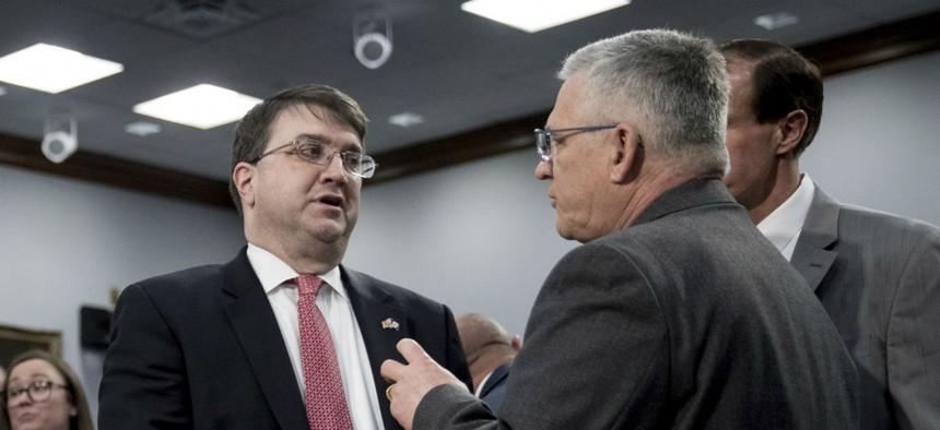 Veterans Affairs Secretary Robert Wilkie, left, speaks with Veterans Health Administration Executive in Charge, Dr. Richard Stone, right, before a House Appropriations subcommittee hearing on budget on March 27.