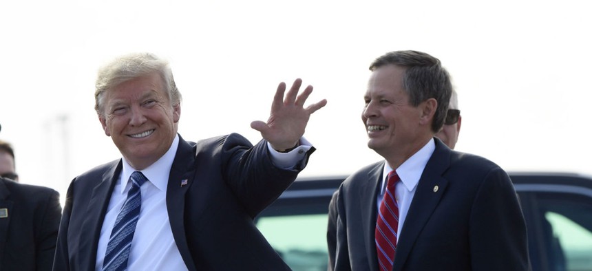 Montana Sen. Steve Daines, right, said he successfully lobbied President Trump to keep open a Forest Service Job Corps center slated for closure. 