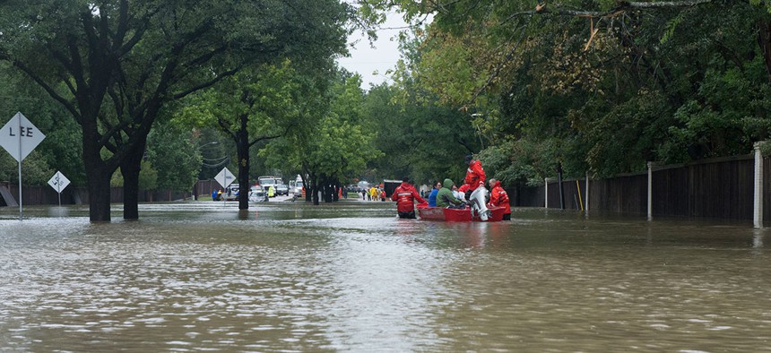A Coast Guard Flood Punt Team transports a family across a flooded neighborhood in Houston in 2017.