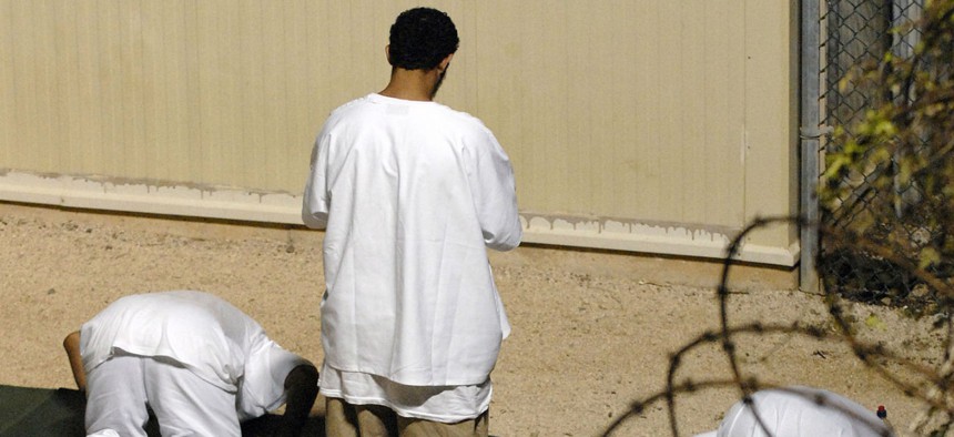 Detainees at Guantanamo participate in morning prayer before sunrise inside Camp Delta in 2010.