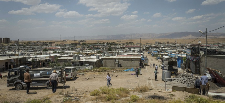 People walk in the Domiz camp for Syrian refugees, near the town of Dohuk, Iraq in 2018.