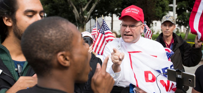 Two people argue during an immigration rally in Los Angeles in 2018.