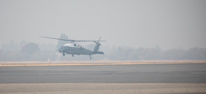 Marine One with President Donald J. Trump aboard departs in a smoky haze from Beale Air Force Base, Calif. after the wildfires in November.