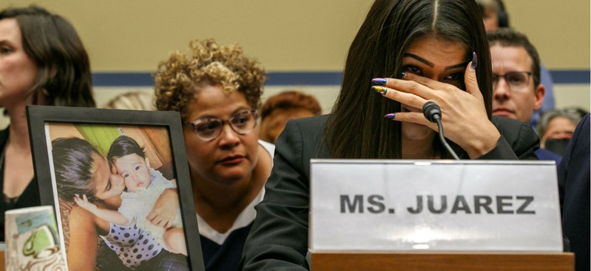 Yazmin Juárez reacts as a photos of her daughter, Mariee, who died after being released from detention by U.S. Immigration and Customs Enforcement, is placed next to her at a House Oversight subcommittee hearing on Wednesday.