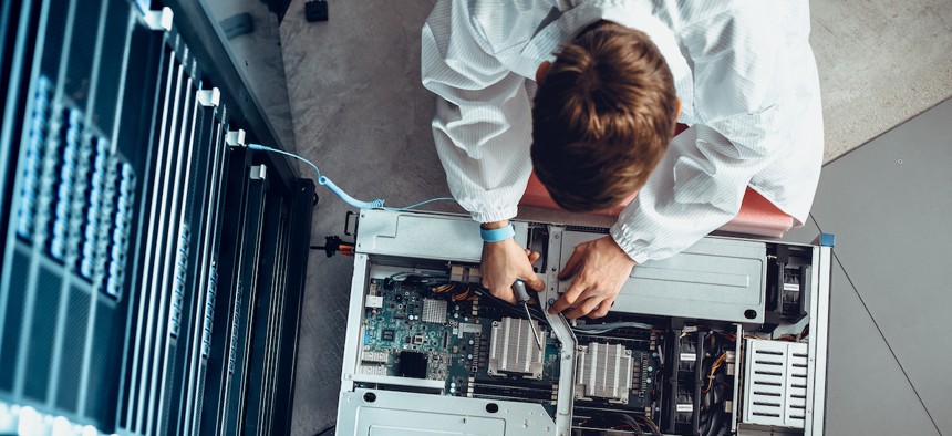 IT Engineer Servicing Part of a Supercomputer.