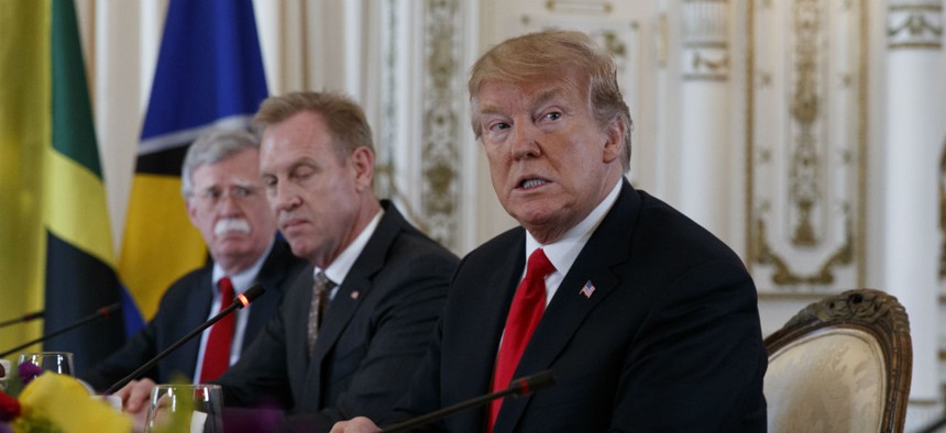 National Security Adviser John Bolton, then-acting Defense Secretary Patrick Shanahan and President Donald Trump during a meeting at Mar-A Lago in March.