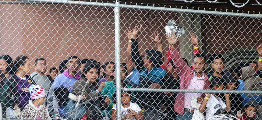 Central American migrants wait for food in a pen erected by U.S. Customs and Border Protection to process a surge of migrant families and unaccompanied minors in El Paso in May.