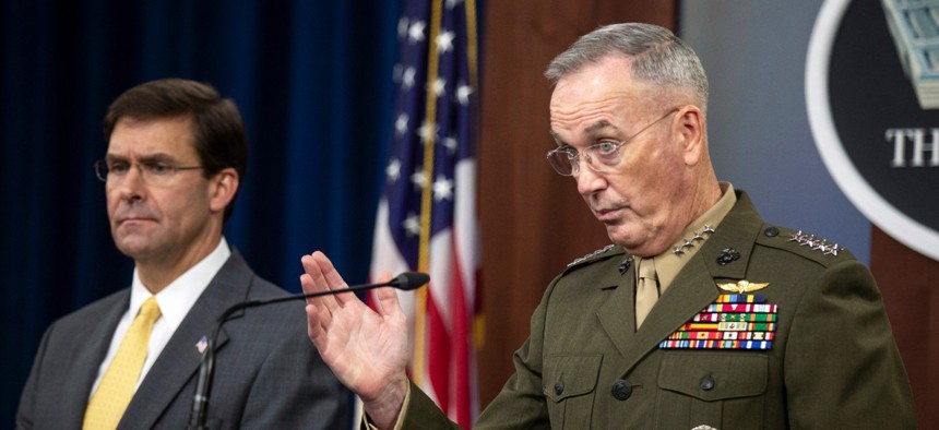 Joint Chiefs Chairman Gen. Joseph Dunford with Secretary of Defense Mark Esper speaks to reporters during a briefing at the Pentagon on Wednesday.