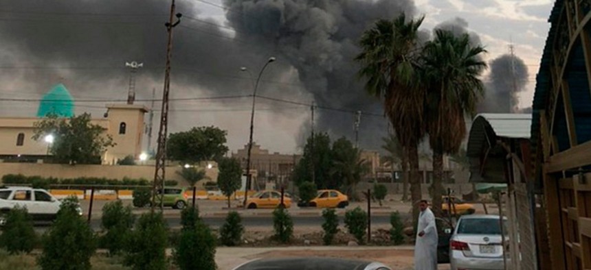 On Aug. 12, 2019, plumes of smoke rise after an explosion at a military base southwest of Baghdad, Iraq.