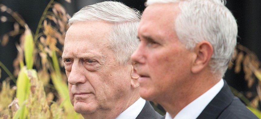 Mattis and Mike Pence walk together in 2018.