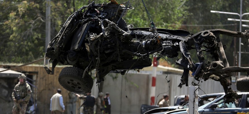 Resolute Support forces remove wreckage after the September 5 car-bomb explosion in Kabul.