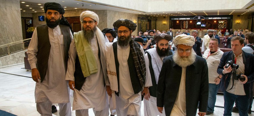 Mullah Abdul Ghani Baradar, the Taliban group's top political leader, third from left, arrives with other members of the Taliban delegation for talks in Moscow, Russia