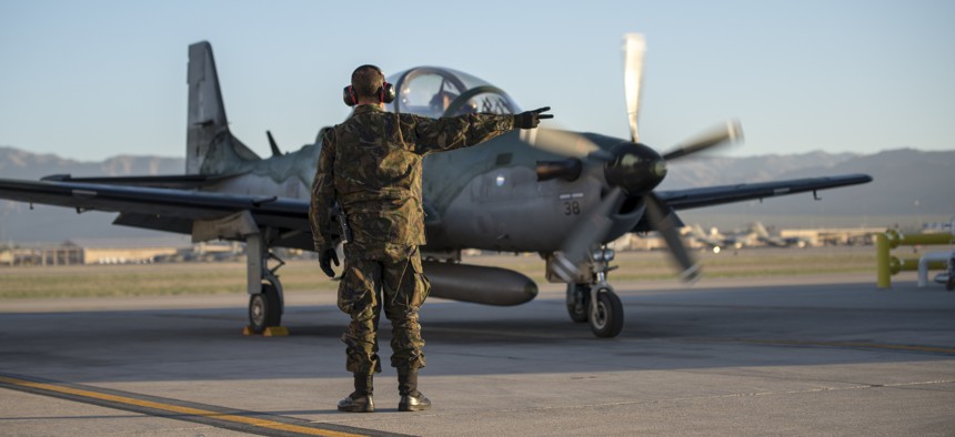 1st Sgt. DeBarros, a crew chief with the Brazilian Air Force, goes over pre-flight checks during Green Flag-West 19-8 at Nellis Air Force Base, Las Vegas, Nevada, June 8, 2019. 