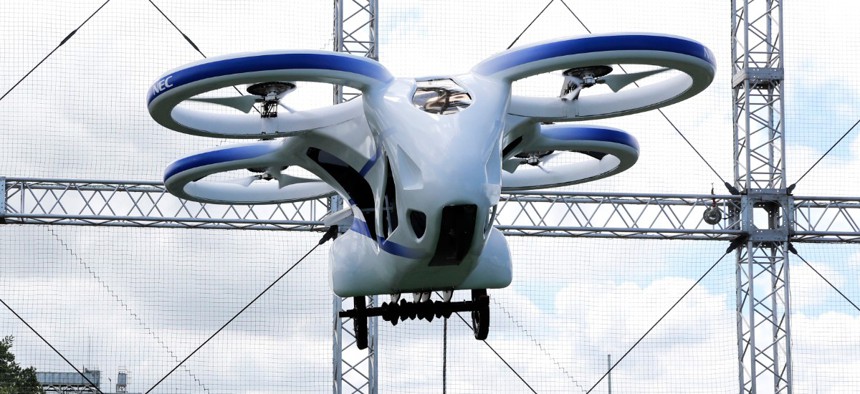NEC Corp.'s machine with propellers hovers at the company's facility in Abiko near Tokyo, Monday, Aug. 5, 2019. The Japanese electronics maker showed a "flying car," a large drone-like machine with four propellers that hovered steadily for about a minute.