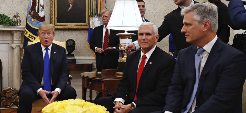 Then-presidential envoy Robert O'Brien, right, attends an Oval Office press conference with President Donald Trump in March 2019. At back, to the right of Trump, is national security adviser John Bolton.