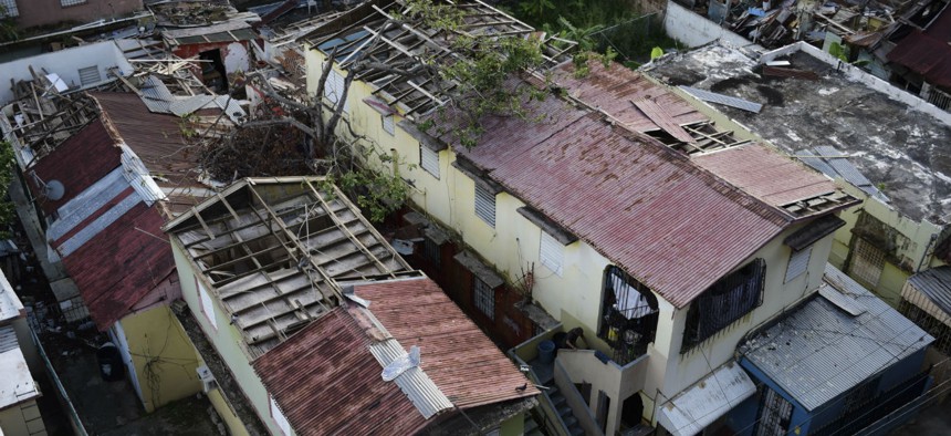 Roofs damaged by Hurricane Maria remain exposed to rainy weather conditions in San Juan, Puerto Rico, in November 2017. 