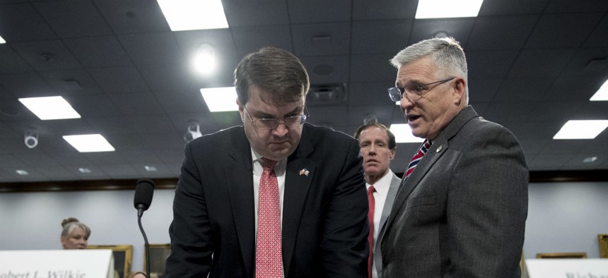 Veterans Affairs Secretary Robert Wilkie, left, speaks with Veterans Health Administration Executive in Charge, Dr. Richard Stone, right, before a budget hearing in March.