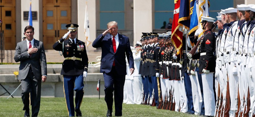 President Donald Trump, right, and Secretary of Defense Mark Esper, left, salute the flags, during a full honors welcoming ceremony for Esper at the Pentagon on July 25.