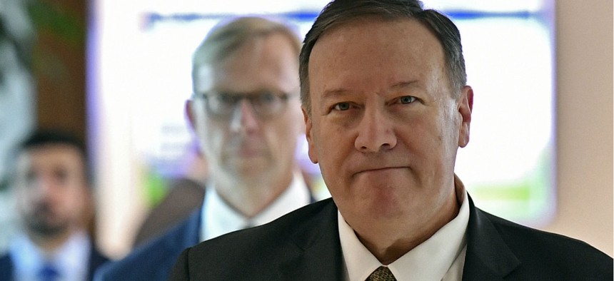 U.S. Secretary of State Mike Pompeo speaks to reporters before departing from al-Bateen Air Base in the United Arab Emirates on Sept. 19 as U.S. special representative on Iran Brian Hook, listens. 