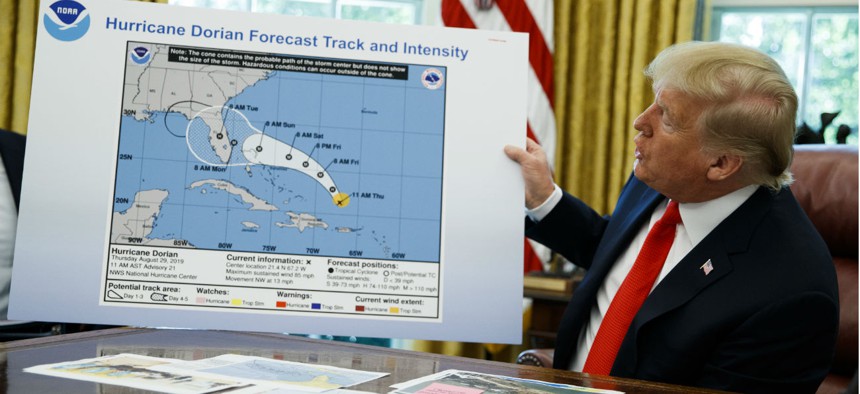 President Trump holds up a chart of Hurricane Dorian's projected path during a briefing on Sept. 4. 