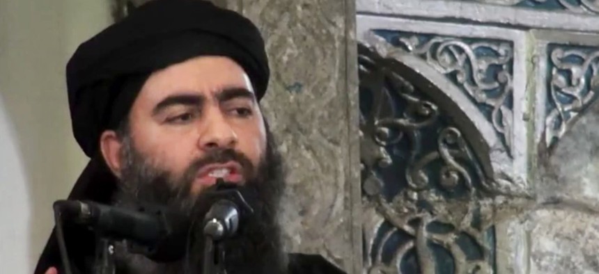  This file image made from video posted on a militant website July 5, 2014, purports to show the leader of the Islamic State group, Abu Bakr al-Baghdadi, delivering a sermon at a mosque in Iraq during his first public appearance.