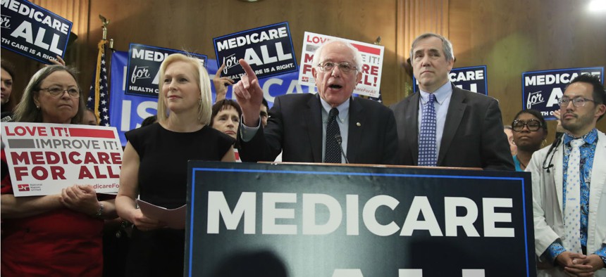Sen. Bernie Sanders, I-Vt., joined by, Sen . Kirsten Gillibrand, D-N.Y., front left, and Sen. Jeff Merkley, D-Ore., front right, introduces the Medicare for All Act of 2019 on Capitol Hill in April. 