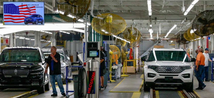 Ford's employees work on a Lincoln Aviator and Ford Explorer lines at Ford's Chicago Assembly Plant in June.