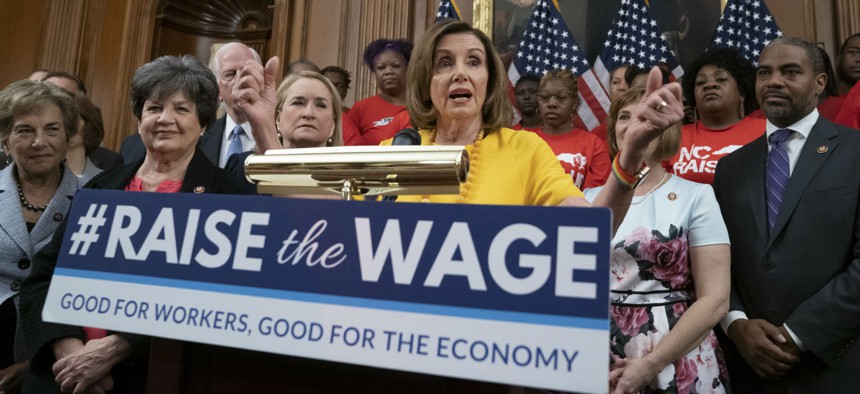 House Speaker Nancy Pelosi rallies for a higher federal minimum wage in July. Some states and localities have already passed laws that will raise the minimum wage to $15 per hour, but the federal government has yet to follow suit. 