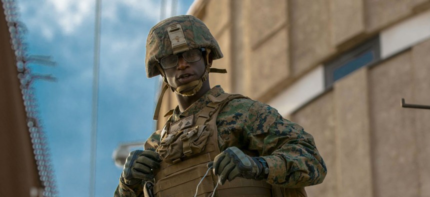 U.S. Marine Corps Lance Cpl. Jente Brothers, assigned to Special Purpose Marine Air-Ground Task Force 7, stands on a forklift that is being used to fortify fencing along the Calexico West Port of Entry in Calexico, California on Nov. 17, 2018.