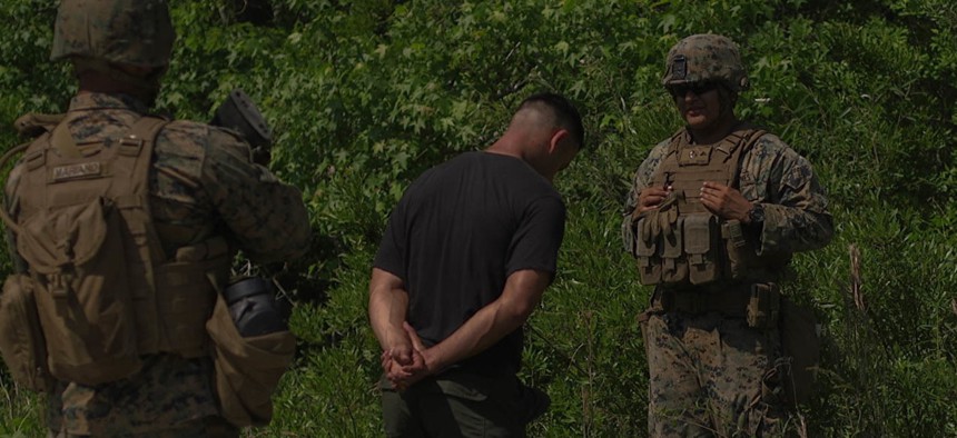 U.S. Marine Corps Lance Cpl. Ulysses Sebastian Brindiz, a military policeman with 2nd Law Enforcement Battalion (LE Bn), II Marine Expeditionary Force, Information Group tactically questions a detainee during an exercise in LZ Phoenix, N.C., May 18, 2019.