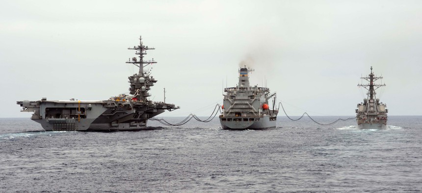 The fleet replenishment oiler USNS Henry J. Kaiser (T-AO-187) refuels the aircraft carrier USS Theodore Roosevelt (CVN 71) and the guided-missile destroyer USS Higgins (DDG 76) during a replenishment-at-sea. 