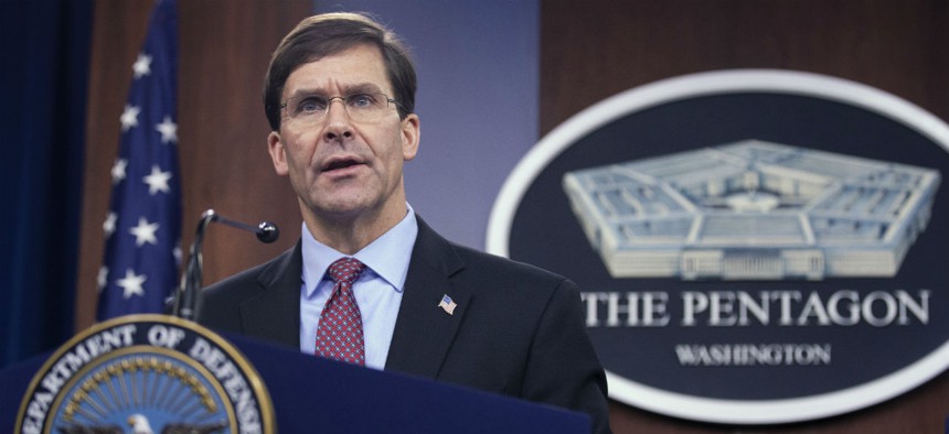 Defense Secretary Mark Esper speaks at a news conference Tuesday. The Defense Department has said it will strengthen protections for contractors working overseas. 