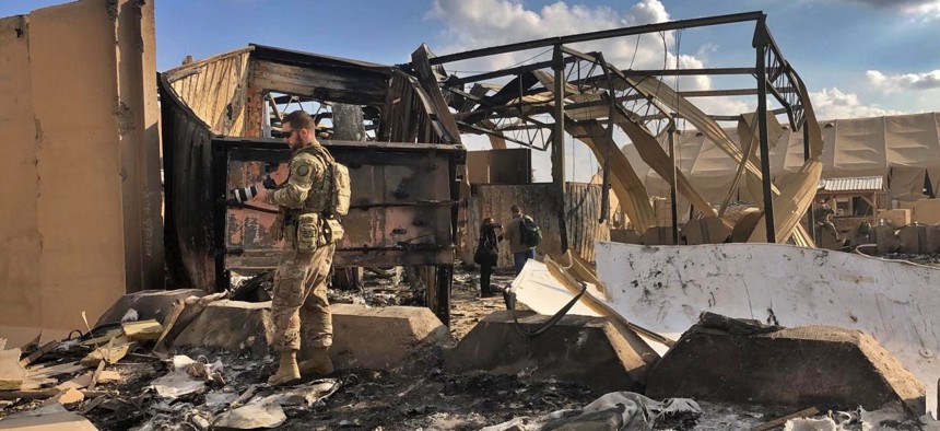 U.S. soldiers inspect rubble at a site of Iranian bombing, in Ain al-Asad air base, Anbar, Iraq, Monday, Jan. 13, 2020. 