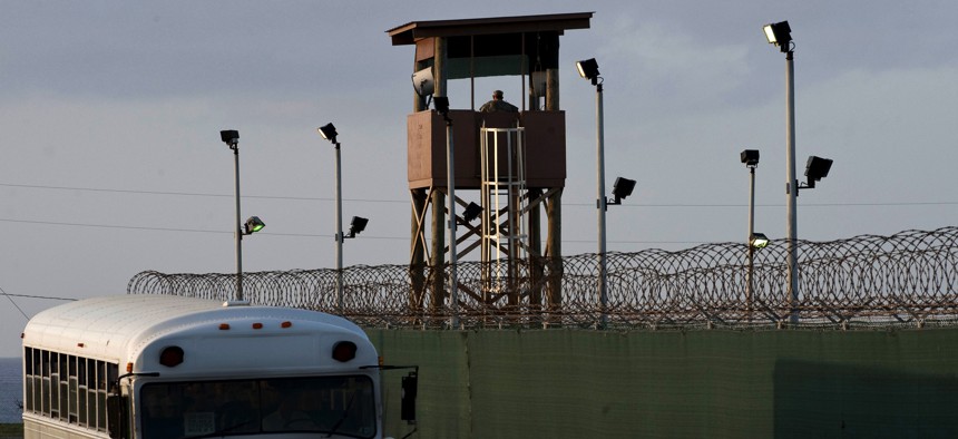 A soldier assigned to the 115th Military Police Company of the Rhode Island Army National Guard stands watch in a guard tower at Camp Delta, Joint Task Force Guantanamo  in 2010.