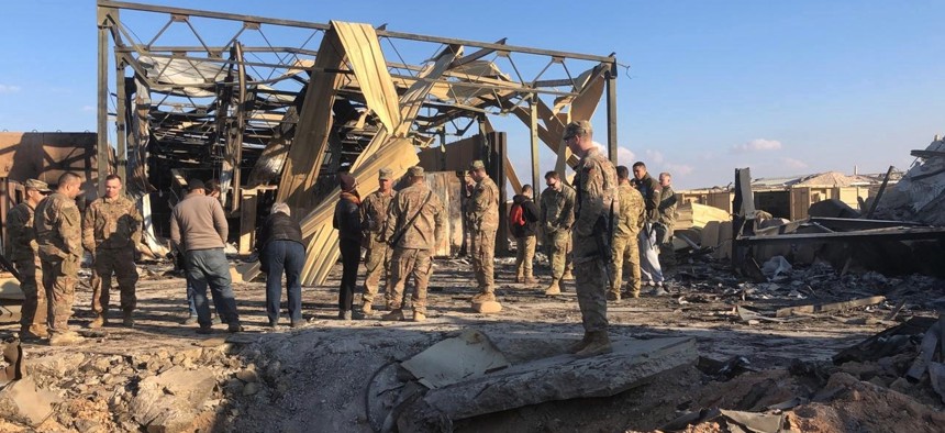 U.S. soldiers stand at a site of Iranian bombing at Ain al-Asad air base in Anbar, Iraq, Monday, Jan. 13, 2020.